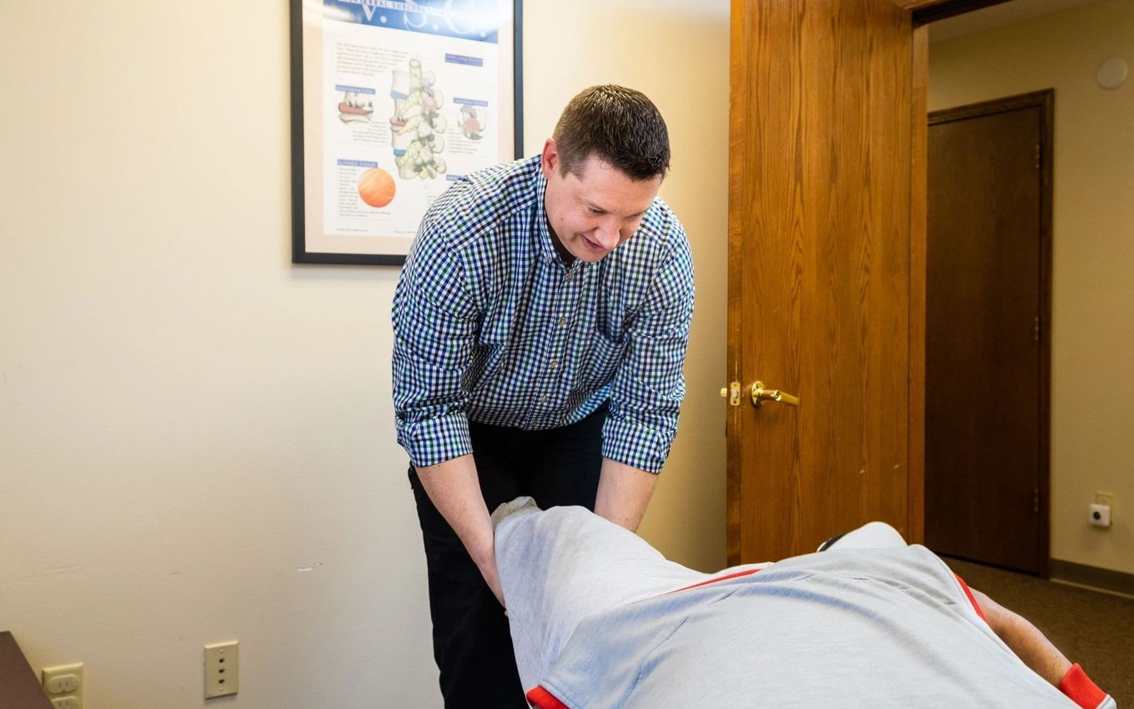 Dr. Matthew Wunderlich adjusting a patient at Wunderlich Chiropractic in Fitchburg