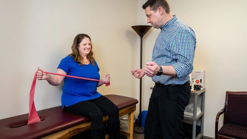 A patient performing a resistance band exercise at Wunderlich Chiropractic